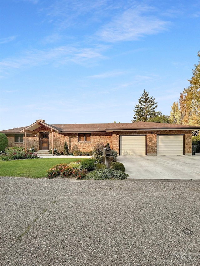 view of front facade featuring a garage, concrete driveway, brick siding, and a front lawn