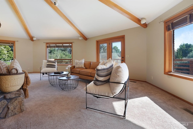 living room with vaulted ceiling with beams, baseboards, a wealth of natural light, and light colored carpet