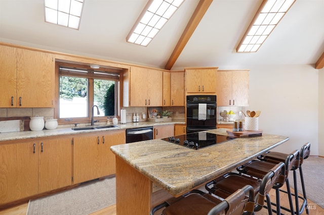 kitchen with lofted ceiling with beams, a sink, a kitchen breakfast bar, black appliances, and tasteful backsplash