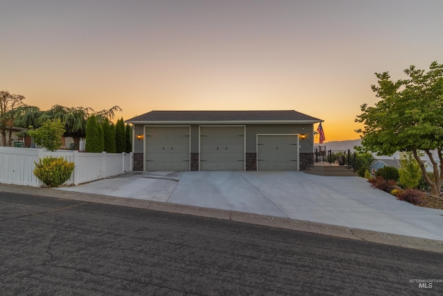 view of garage at dusk