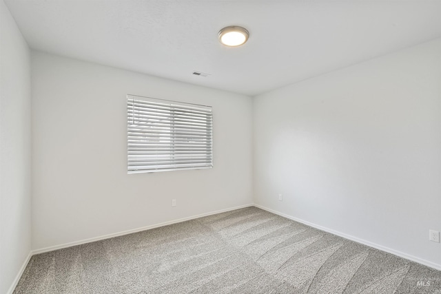 unfurnished room with visible vents, carpet floors, and baseboards