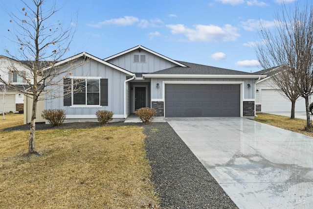 single story home featuring a garage, stone siding, concrete driveway, and a front yard