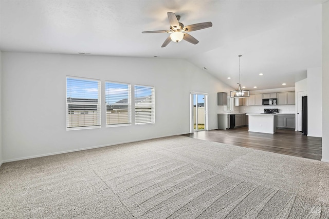 unfurnished living room with dark carpet, a ceiling fan, and lofted ceiling