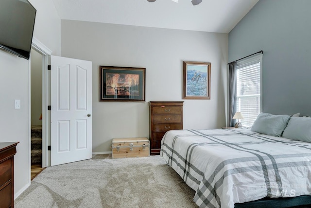 carpeted bedroom with baseboards, lofted ceiling, and ceiling fan