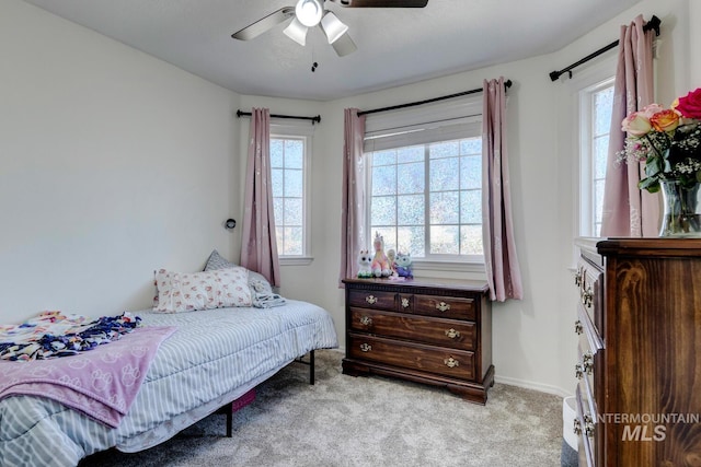 bedroom with baseboards, a ceiling fan, and carpet