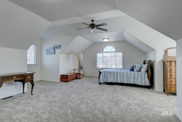 carpeted bedroom with visible vents, ceiling fan, baseboards, and lofted ceiling