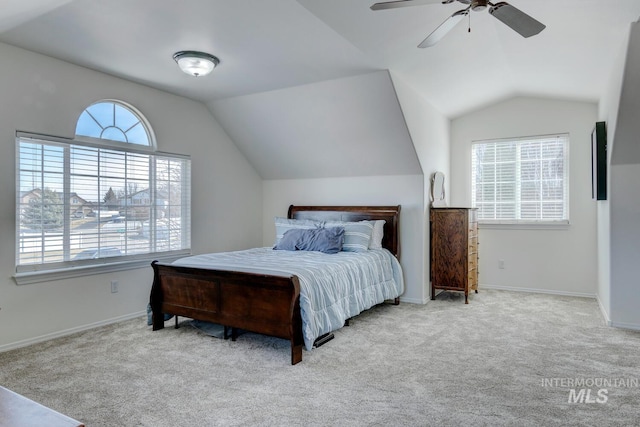 bedroom featuring lofted ceiling, multiple windows, carpet, and baseboards