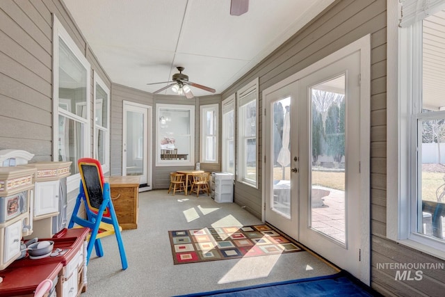 sunroom featuring french doors and a ceiling fan