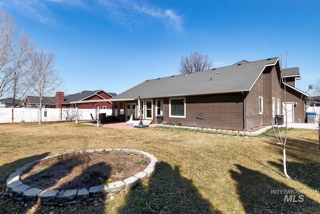 rear view of house featuring a lawn, central AC, a patio, and fence