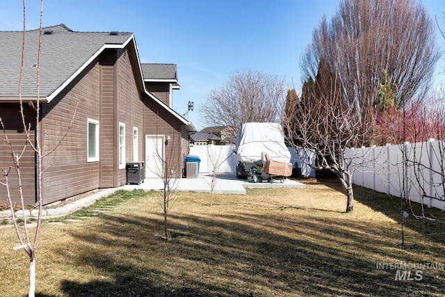 view of yard featuring cooling unit, a patio area, and a fenced backyard