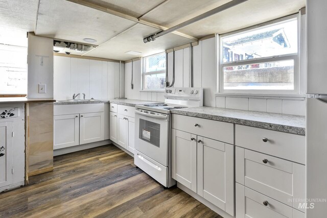 405 N 2nd E, Mountain Home, ID 83647 - kitchen featuring white appliances, dark wood-type flooring, white cabinets, a sink, and light stone counters
