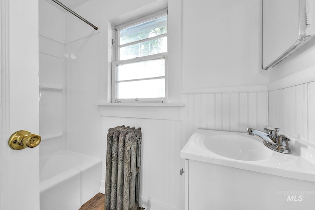 405 N 2nd E, Mountain Home, ID 83647 - bathroom featuring vanity, a wainscoted wall, and shower / bathtub combination