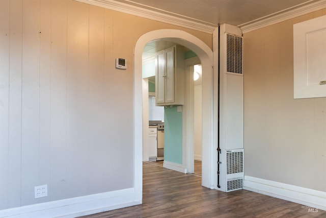 405 N 2nd E, Mountain Home, ID 83647 - unfurnished room with a heating unit, arched walkways, dark wood-style flooring, ornamental molding, and baseboards