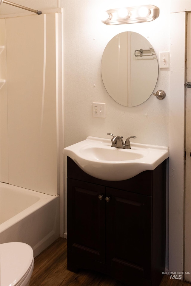 405 N 2nd E, Mountain Home, ID 83647 - full bathroom featuring vanity, wood finished floors, toilet, and  shower combination