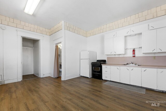 405 N 2nd E, Mountain Home, ID 83647 - kitchen featuring black gas range, freestanding refrigerator, a sink, light countertops, and white cabinetry