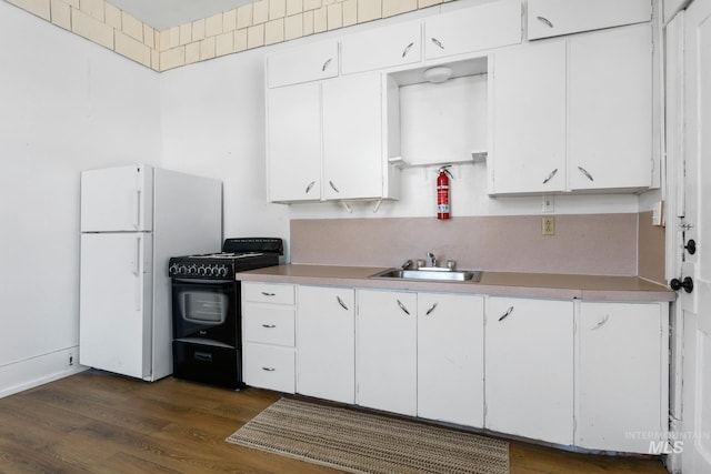 405 N 2nd E, Mountain Home, ID 83647 - kitchen with black electric range, a sink, freestanding refrigerator, and light countertops
