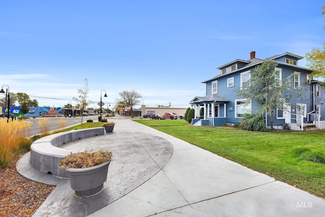 405 N 2nd E, Mountain Home, ID 83647 - view of side of home with a chimney and a yard