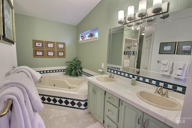 bathroom featuring vanity, lofted ceiling, and tiled tub