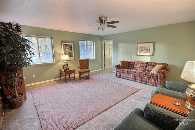 living room featuring a textured ceiling, ceiling fan, and carpet floors