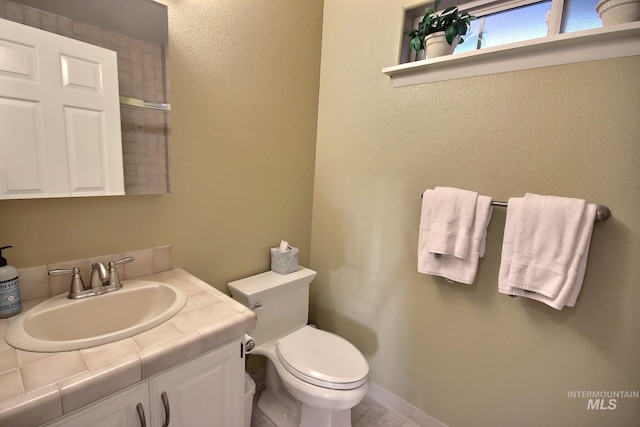 bathroom featuring toilet and vanity