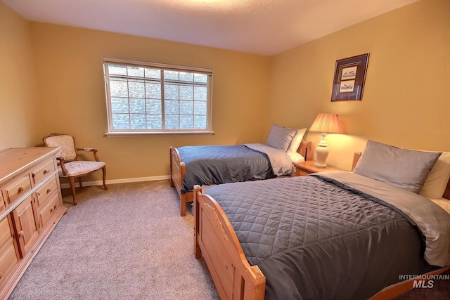 bedroom featuring light carpet