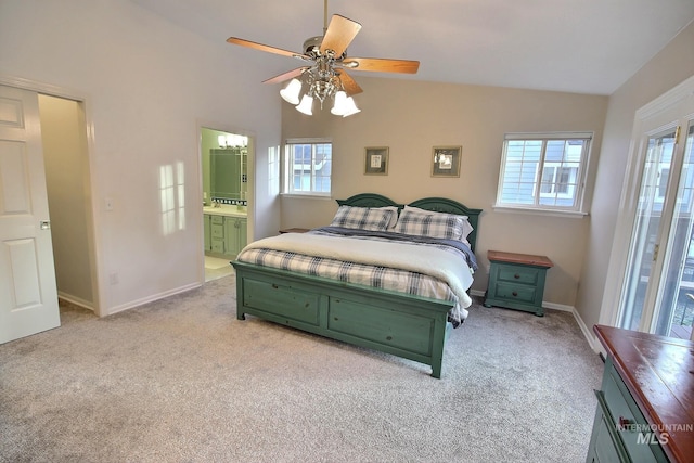 bedroom with vaulted ceiling, light carpet, ceiling fan, and ensuite bathroom