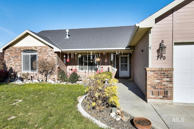 view of front facade with a garage, a front yard, and a porch