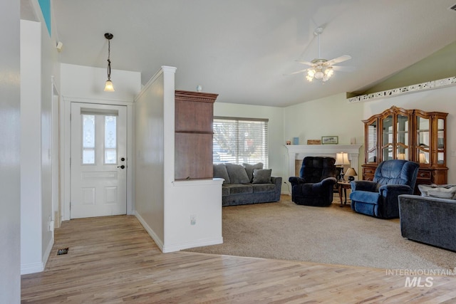 entryway featuring plenty of natural light, lofted ceiling, ceiling fan, and light hardwood / wood-style flooring