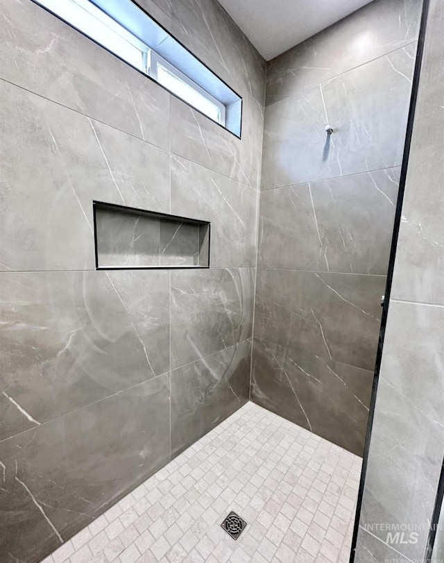 bathroom with tiled shower