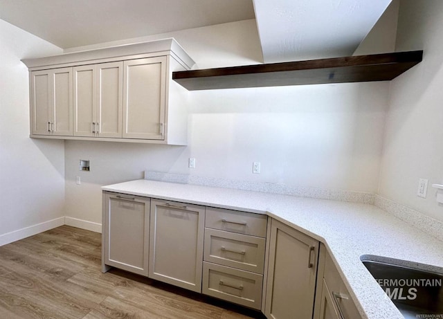 kitchen featuring light wood-type flooring and gray cabinets