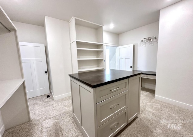 walk in closet featuring light carpet