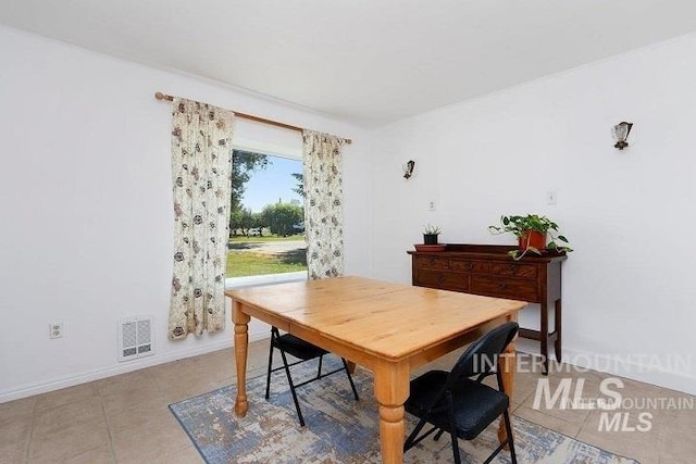 dining area with light tile patterned flooring, baseboards, and visible vents