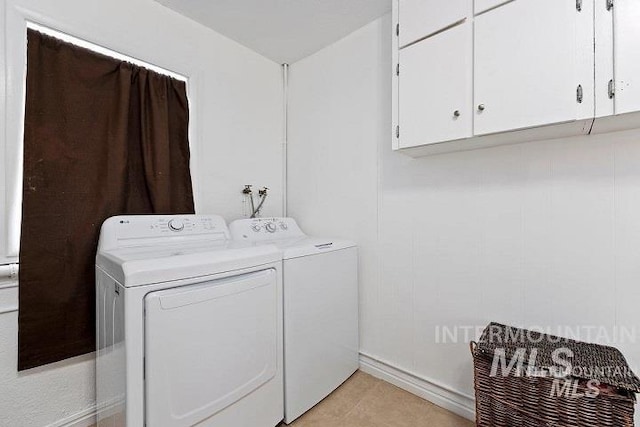 washroom with washing machine and dryer and cabinet space