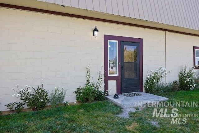 property entrance featuring concrete block siding