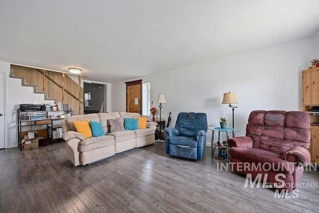 living area with dark wood-style flooring and stairs