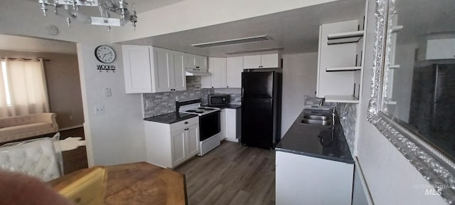 kitchen with sink, black refrigerator, white cabinets, and white range with electric stovetop