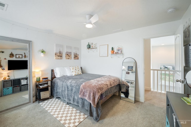 bedroom featuring light carpet and ceiling fan