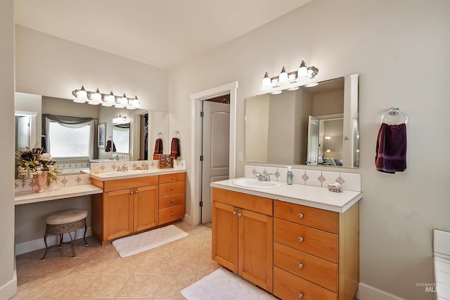 bathroom with backsplash, tile patterned floors, and vanity