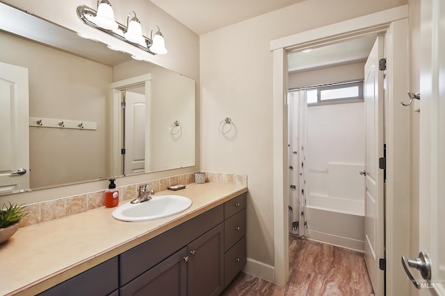 bathroom with vanity, hardwood / wood-style floors, and shower / tub combo with curtain