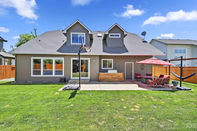 rear view of house with a yard and a patio