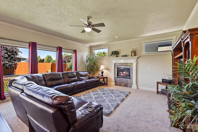 living room featuring crown molding, a fireplace, a textured ceiling, carpet floors, and ceiling fan