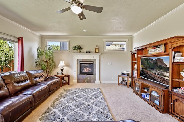 living room featuring a wealth of natural light, crown molding, light carpet, and a fireplace