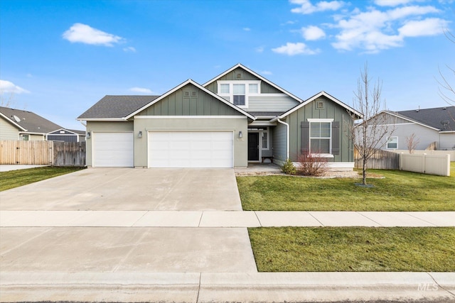 view of front of property with a garage and a front lawn