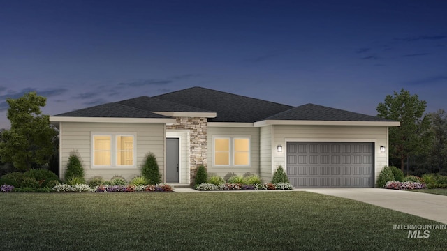 view of front of home featuring a garage and a front yard