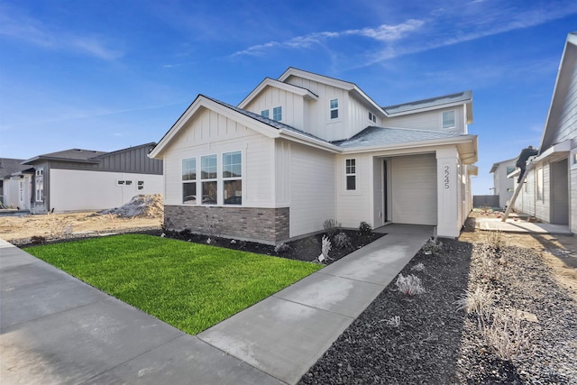 2300 E Valensole St, Meridian, ID 83642 - view of front of property with board and batten siding, a front yard, and brick siding