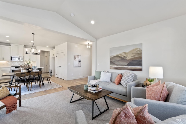 living room featuring a notable chandelier, light wood finished floors, lofted ceiling, recessed lighting, and baseboards