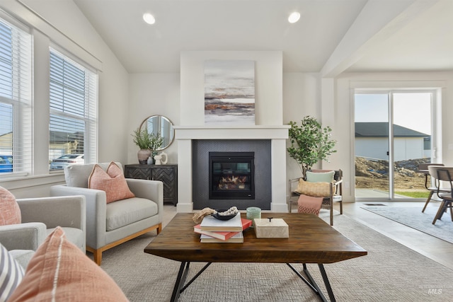 living room featuring a glass covered fireplace and recessed lighting