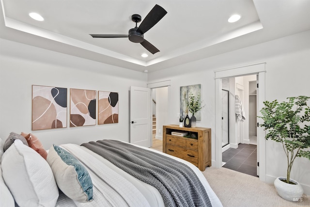 carpeted bedroom featuring a tray ceiling and recessed lighting