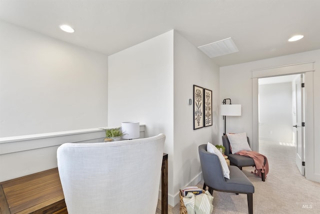 sitting room featuring carpet, baseboards, and recessed lighting