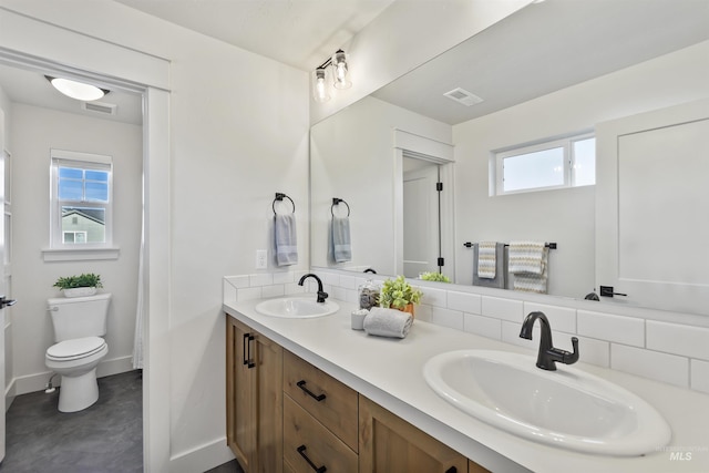 bathroom with plenty of natural light, a sink, and visible vents